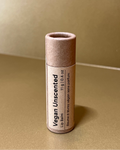 Vegan unscented lip balm tube on a beige background