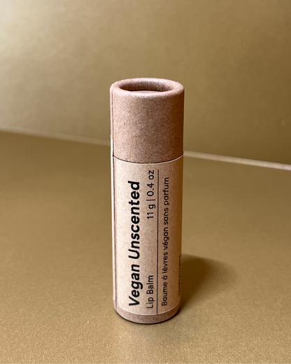 Vegan lip balm unscented tube on a beige background